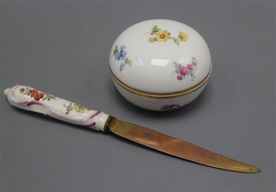 A small Meissen circular box painted with flowers and a porcelain handled knife